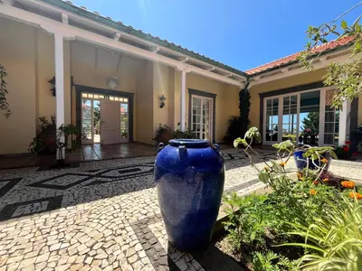 a large blue vase sitting outside of a house at PRIVATE OCEANFRONT DELUXE VILLA PICO 360 VIEWs in Funchal