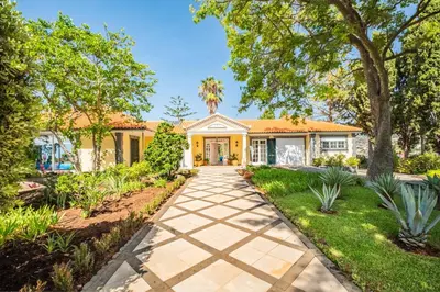 a house with a garden and a walkway at PRIVATE OCEANFRONT DELUXE VILLA PICO 360 VIEWs in Funchal