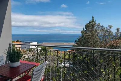 a balcony with a table and a view of the ocean at Titou Apartment Sea View in Santa Cruz