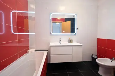a bathroom with a tub and a sink and a bath tub at Titou Apartment Sea View in Santa Cruz