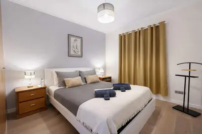 a bedroom with a bed with two blue towels on it at Titou Apartment Sea View in Santa Cruz