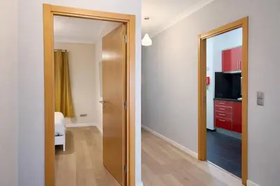 a hallway with a door leading to a room with a television at Titou Apartment Sea View in Santa Cruz