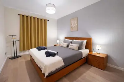 a bedroom with a bed with two bags on it at Titou Apartment Sea View in Santa Cruz