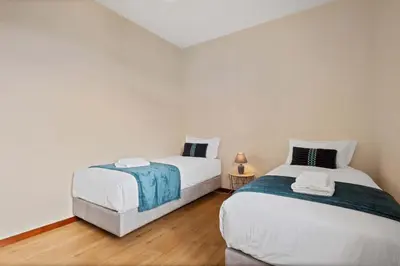 two beds sitting next to each other in a bedroom at Villa Por do Sol in Ponta do Sol