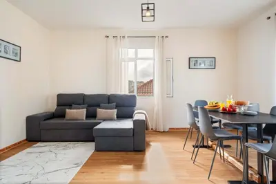a living room with a couch and a table at Villa Por do Sol in Ponta do Sol