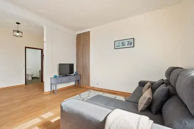 a living room with a couch and a tv at Villa Por do Sol in Ponta do Sol