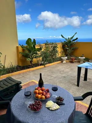 a table with a bunch of fruit and wine glasses at Jardim do Caniço in Caniço