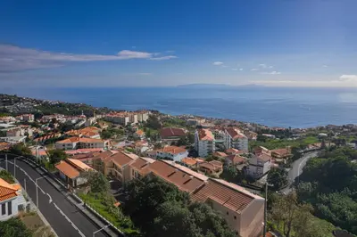 an aerial view of a city and the ocean at Jardim do Caniço in Caniço