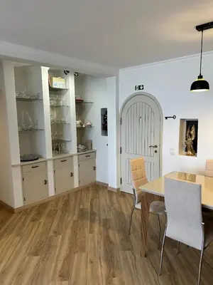 a dining room with a table and chairs at Jardim do Caniço in Caniço