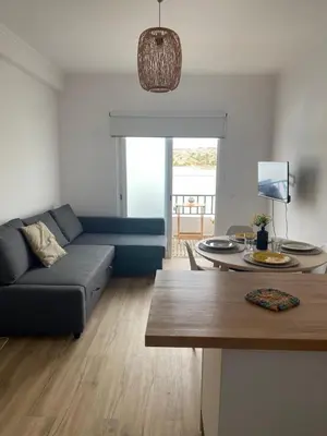 a living room with a couch and a table at Sea La Vie Apartment Porto Santo in Porto Santo