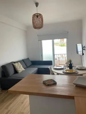 a living room with a couch and a table at Sea La Vie Apartment Porto Santo in Porto Santo