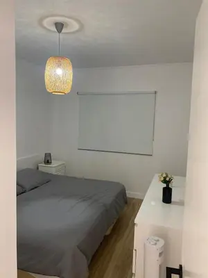 a bedroom with a bed and a white wall at Sea La Vie Apartment Porto Santo in Porto Santo