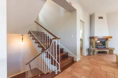 a staircase in a home with a fireplace at Casa dos Namora by Atlantic Holiday in Câmara de Lobos