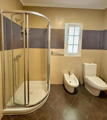 a bathroom with a shower and a toilet and a sink at Vista Ventura in Ponta Delgada
