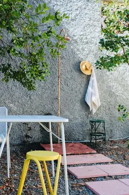 a table and two chairs next to a wall at Araça Studio - Atlantic Mountain Living in São Vicente