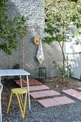 a patio with a table and a table and chairs at Araça Studio - Atlantic Mountain Living in São Vicente