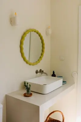 a bathroom with a white sink and a mirror at Araça Studio - Atlantic Mountain Living in São Vicente