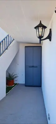 a hallway with a blue door and a light at Refúgio das Regadinhas in Santa Cruz