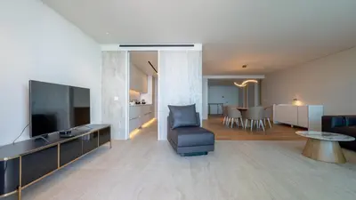 a living room with a couch and a television and a table at Oceanalis by LovelyStay in Funchal
