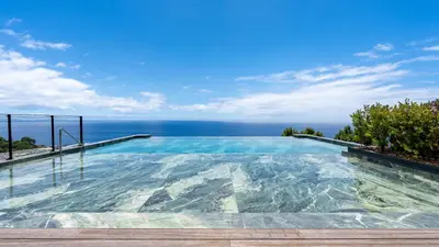 a swimming pool with the ocean in the background at Oceanalis by LovelyStay in Funchal