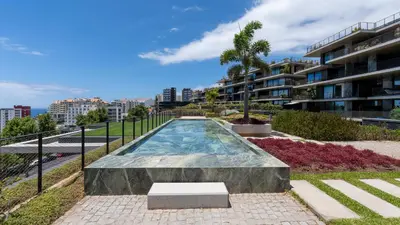 a swimming pool in front of a building at Oceanalis by LovelyStay in Funchal