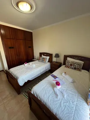 two beds in a bedroom with dolls on them at Casa Costa in Santa Maria Madalena