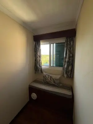 a small window seat in a small room with a window treatment at Casa Costa in Santa Maria Madalena