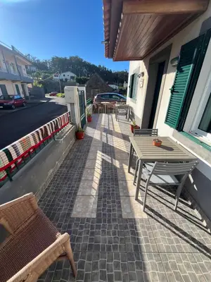 a patio with a table and chairs on a building at Casa Costa in Santa Maria Madalena