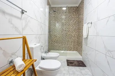 a white bathroom with a toilet and a shower at Estrela house II Calheta Madeira in Calheta