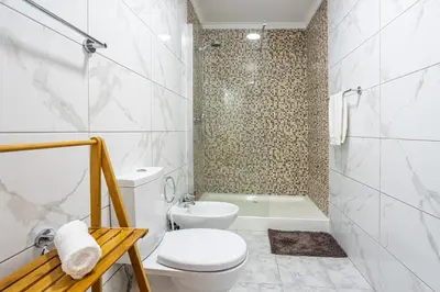 a white bathroom with a toilet and a shower at Estrela house II Calheta Madeira in Calheta
