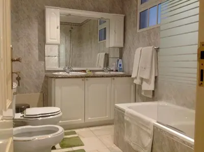 a bathroom with a tub and a toilet and a sink at Apart Monumental in Funchal