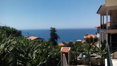 a view of the ocean from a house at Apart Monumental in Funchal