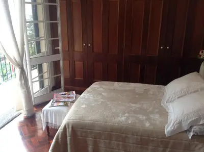 a bedroom with a bed and a large window at Apart Monumental in Funchal