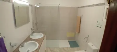 a white bathroom with two sinks and a shower at Apart Monumental in Funchal
