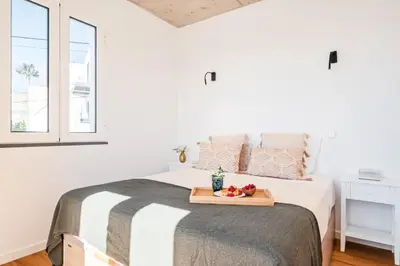 a bedroom with a bed with a tray of fruit on it at The Vinehill House in Câmara de Lobos