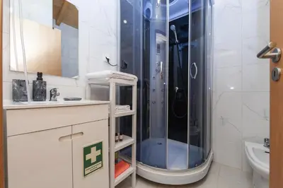 a bathroom with a shower and a sink at A28 - Castela Street Townhouse in Espiche in Luz