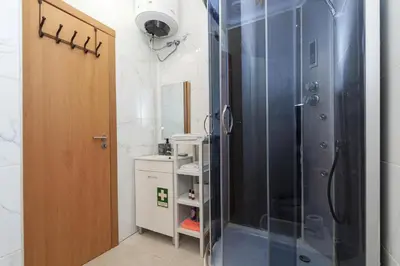 a bathroom with a shower with a glass door at A28 - Castela Street Townhouse in Espiche in Luz