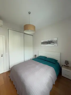 a bedroom with a large bed and a pendant light at Sunny modern 2 bedroom apartment in Funchal