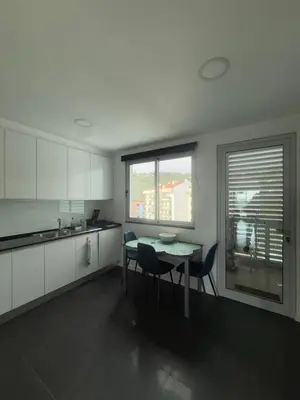 a kitchen with a table and chairs and a window at Sunny modern 2 bedroom apartment in Funchal