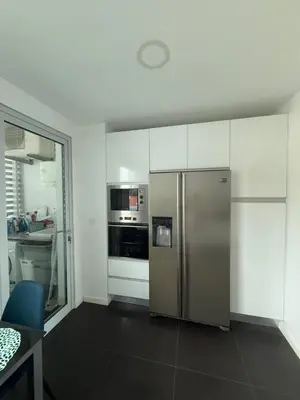 a kitchen with a stainless steel refrigerator and appliances at Sunny modern 2 bedroom apartment in Funchal