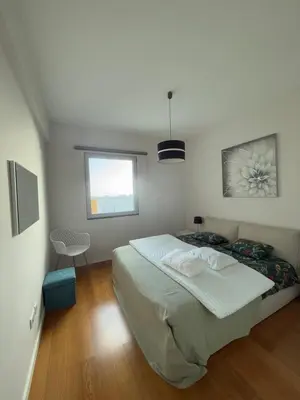 a bedroom with a large bed and a window at Sunny modern 2 bedroom apartment in Funchal