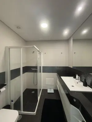 a bathroom with a shower and a toilet and a sink at Sunny modern 2 bedroom apartment in Funchal