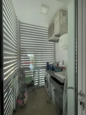 a kitchen with a sink and a window with blinds at Sunny modern 2 bedroom apartment in Funchal
