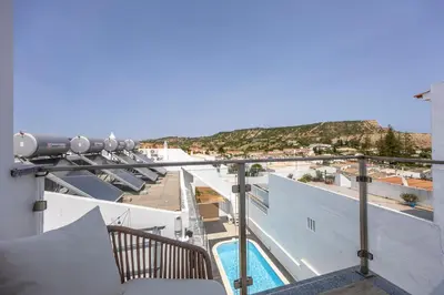 a balcony with a view of a swimming pool at Casa Gio in Luz