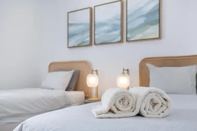 a bedroom with two beds with towels on the bed at Casa Gio in Luz