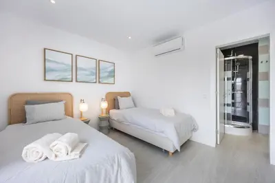 a bedroom with two beds with towels on them at Casa Gio in Luz