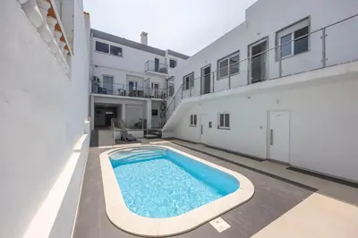 a swimming pool in the courtyard of a building at Casa Gio in Luz