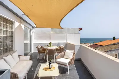 a balcony with a table and chairs and the ocean at Casa Gio in Luz
