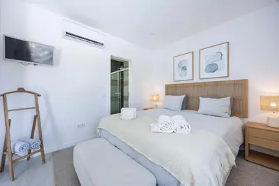 a bedroom with a bed with two towels on it at Casa Gio in Luz