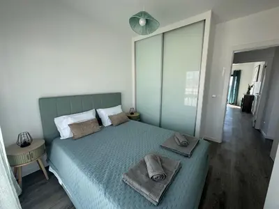 a bedroom with a mirror and a bed and a window at Almar Ocean Retreat in Gaula
